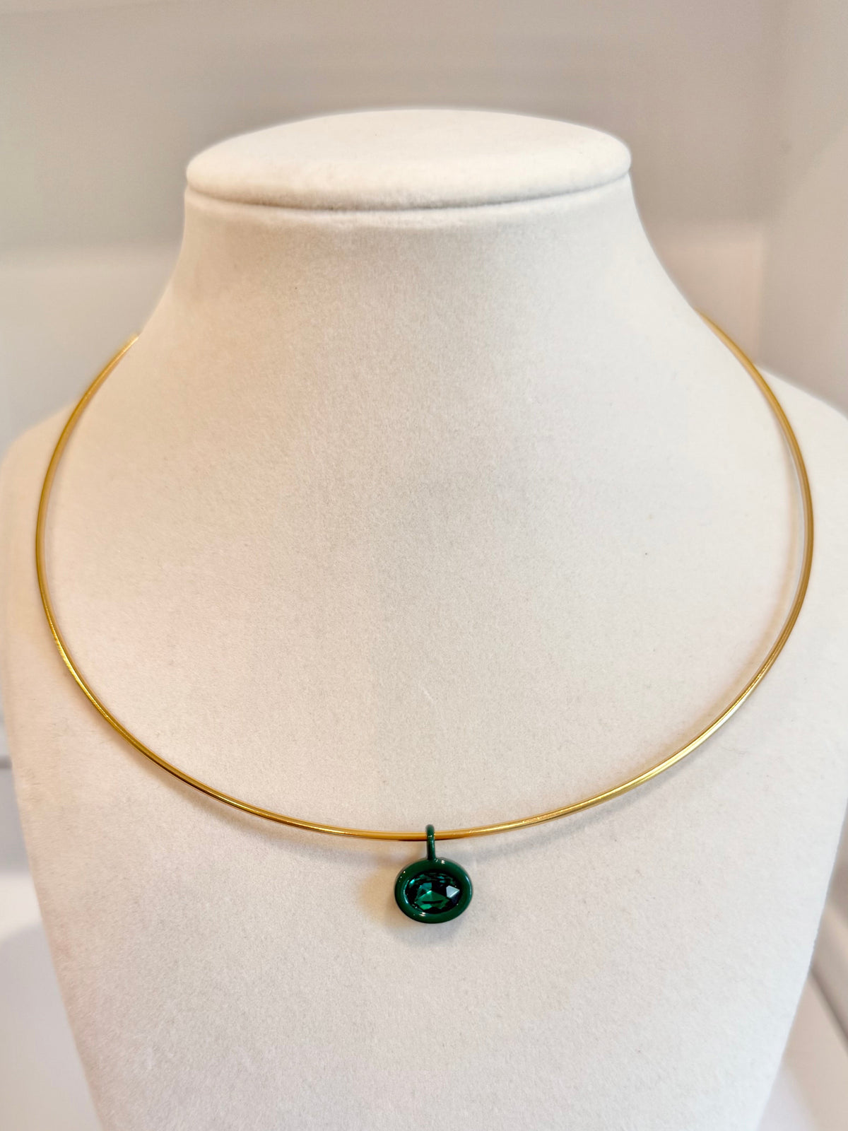 gold collar with green charm