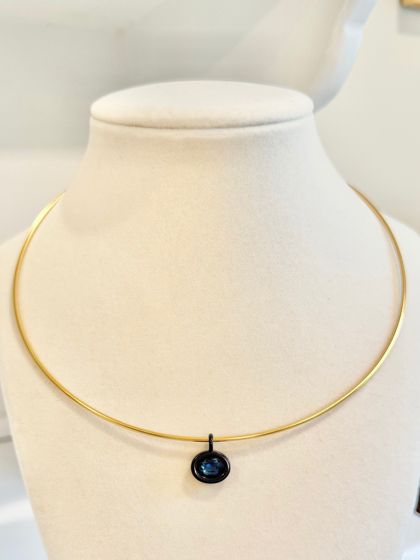 gold collar with navy charm