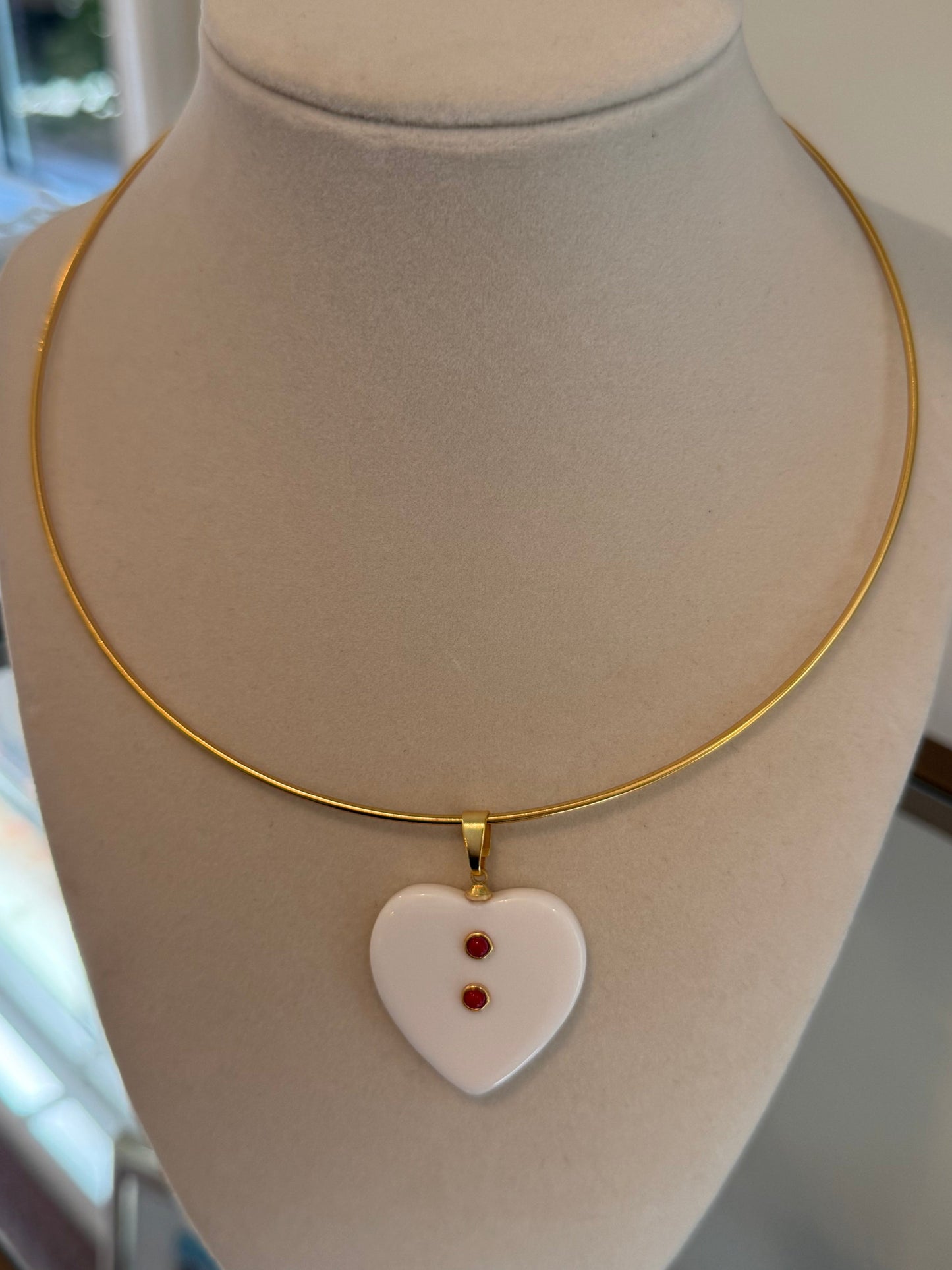 coral resin charm on gold collar